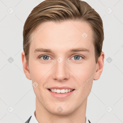 Joyful white young-adult male with short  brown hair and grey eyes