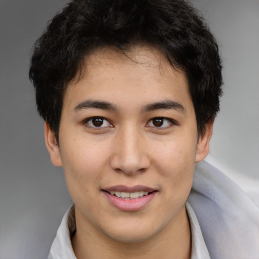 Joyful asian young-adult male with short  brown hair and brown eyes