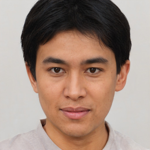 Joyful asian young-adult male with short  brown hair and brown eyes