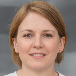 Joyful white adult female with medium  brown hair and grey eyes