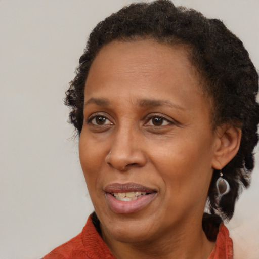 Joyful black adult female with short  brown hair and brown eyes