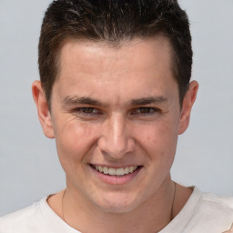 Joyful white adult male with short  brown hair and brown eyes