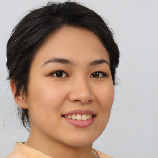 Joyful asian young-adult female with medium  brown hair and brown eyes
