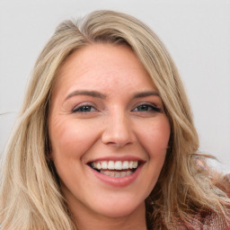 Joyful white young-adult female with long  brown hair and green eyes