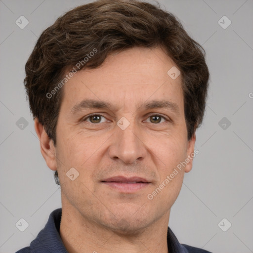 Joyful white adult male with short  brown hair and grey eyes