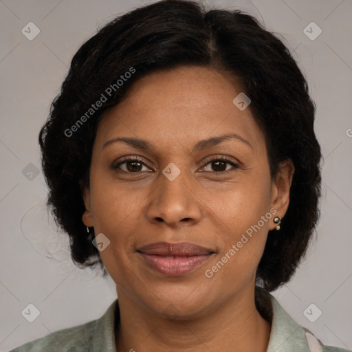 Joyful black adult female with medium  brown hair and brown eyes