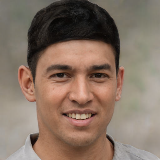 Joyful white young-adult male with short  black hair and brown eyes