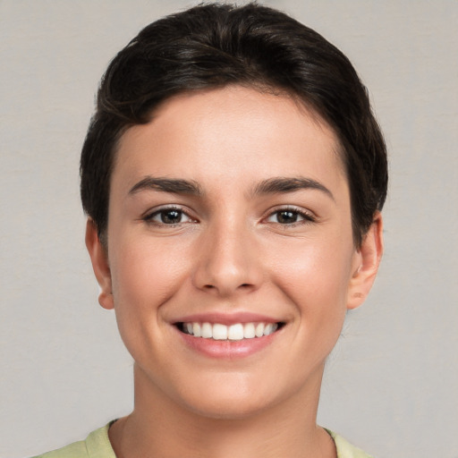 Joyful white young-adult female with short  brown hair and brown eyes