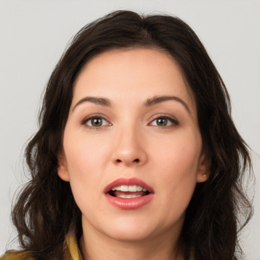 Joyful white young-adult female with long  brown hair and brown eyes