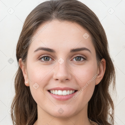 Joyful white young-adult female with long  brown hair and grey eyes