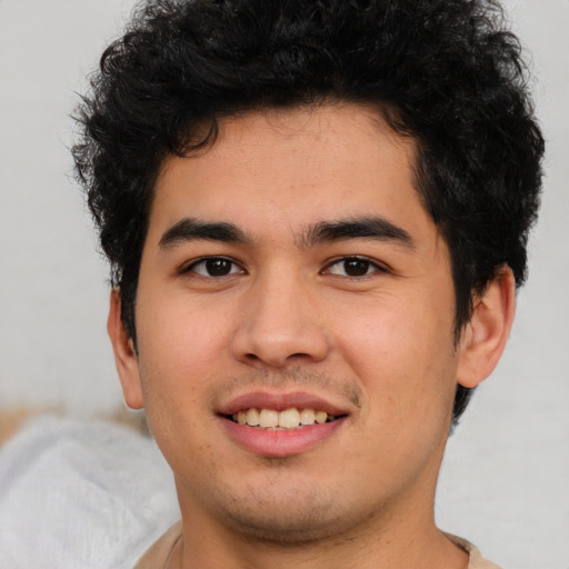 Joyful latino young-adult male with short  brown hair and brown eyes