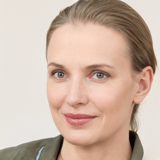 Joyful white young-adult female with medium  brown hair and blue eyes