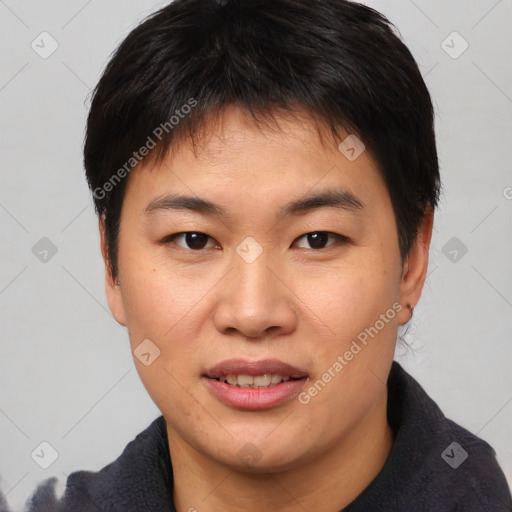 Joyful asian young-adult male with short  brown hair and brown eyes