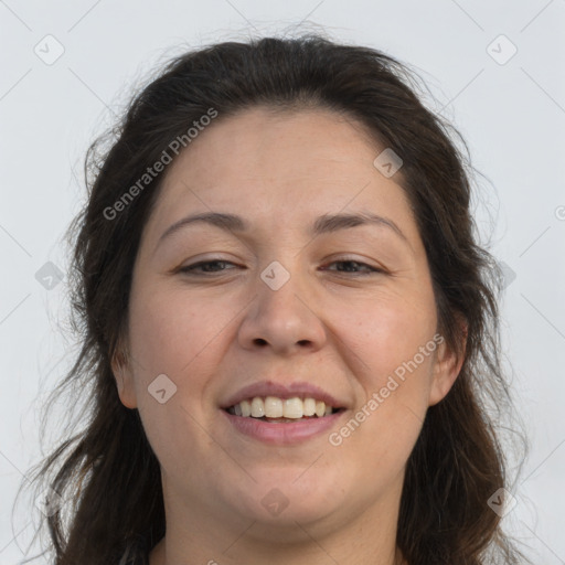 Joyful white adult female with long  brown hair and brown eyes