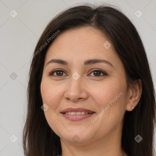 Joyful white adult female with long  brown hair and brown eyes