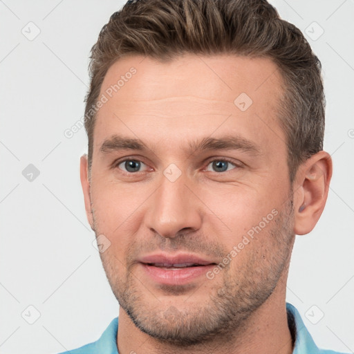 Joyful white young-adult male with short  brown hair and brown eyes