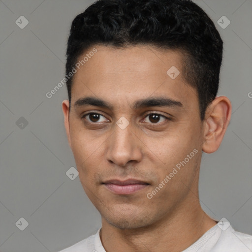 Joyful latino young-adult male with short  black hair and brown eyes