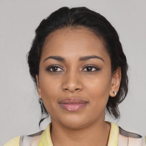 Joyful black young-adult female with medium  black hair and brown eyes