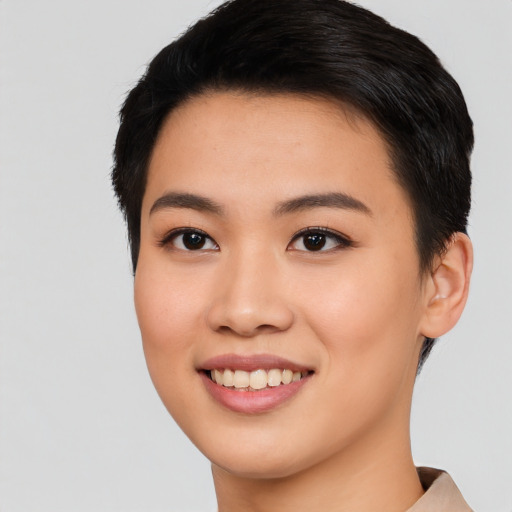 Joyful asian young-adult female with short  black hair and brown eyes