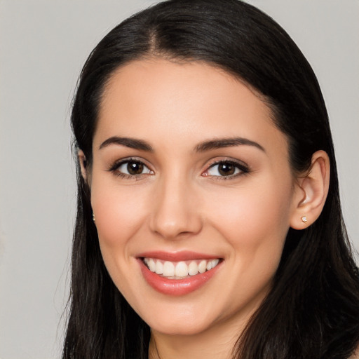 Joyful white young-adult female with long  black hair and brown eyes