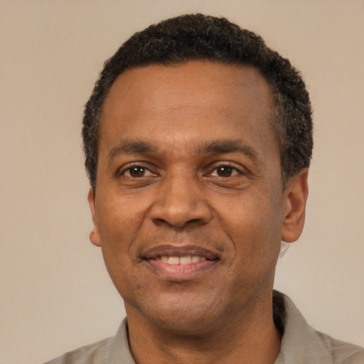 Joyful latino adult male with short  black hair and brown eyes