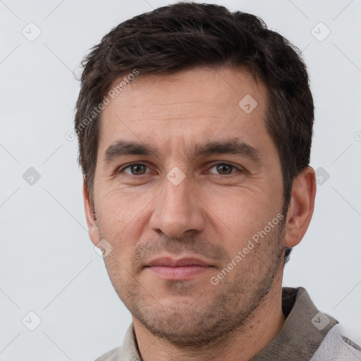 Joyful white adult male with short  brown hair and brown eyes