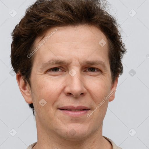 Joyful white adult male with short  brown hair and grey eyes