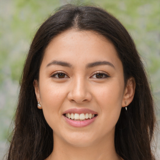 Joyful white young-adult female with long  brown hair and brown eyes