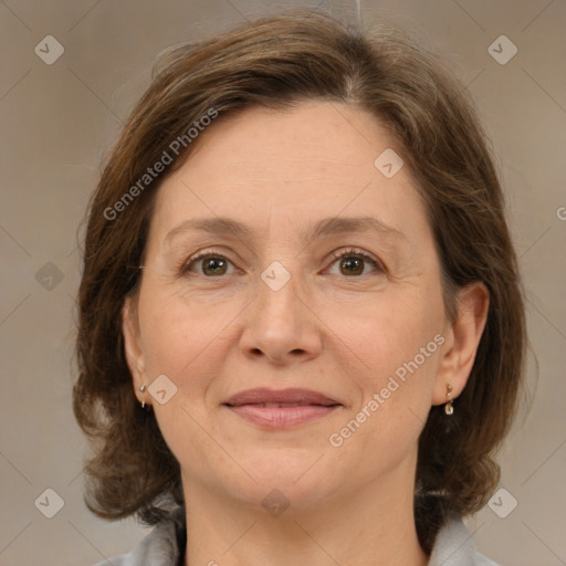 Joyful white adult female with medium  brown hair and grey eyes