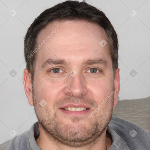 Joyful white adult male with short  brown hair and grey eyes