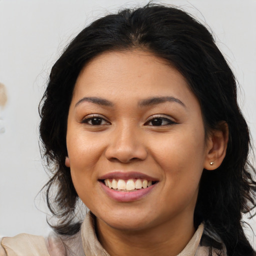 Joyful asian young-adult female with long  brown hair and brown eyes