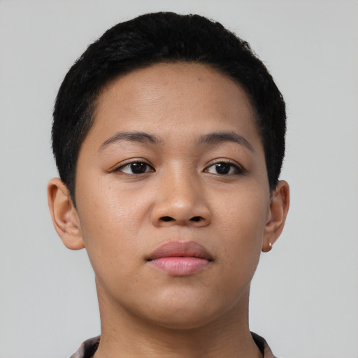 Joyful latino young-adult female with short  black hair and brown eyes