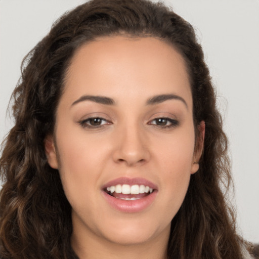 Joyful white young-adult female with long  brown hair and brown eyes