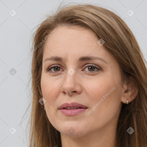 Joyful white adult female with long  brown hair and brown eyes