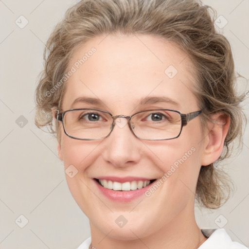 Joyful white adult female with medium  brown hair and blue eyes