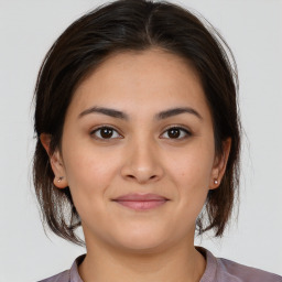 Joyful white young-adult female with medium  brown hair and brown eyes