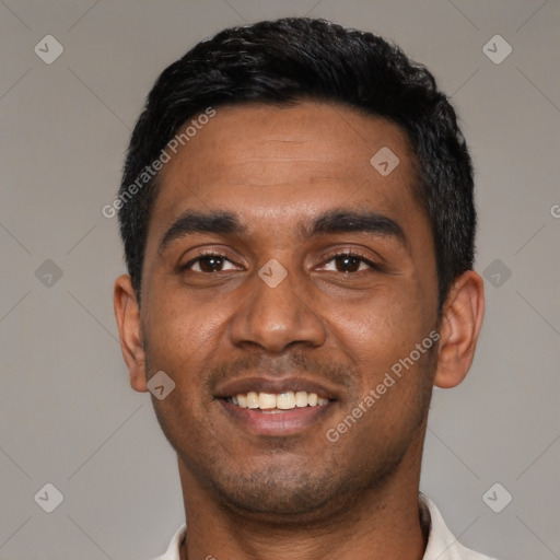 Joyful black young-adult male with short  black hair and brown eyes