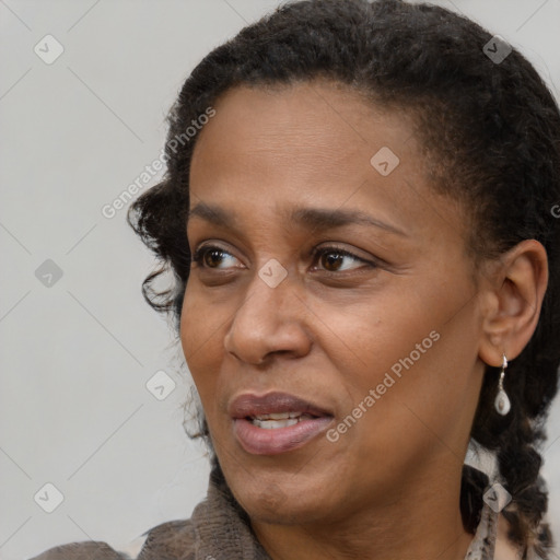 Joyful black adult female with medium  brown hair and brown eyes