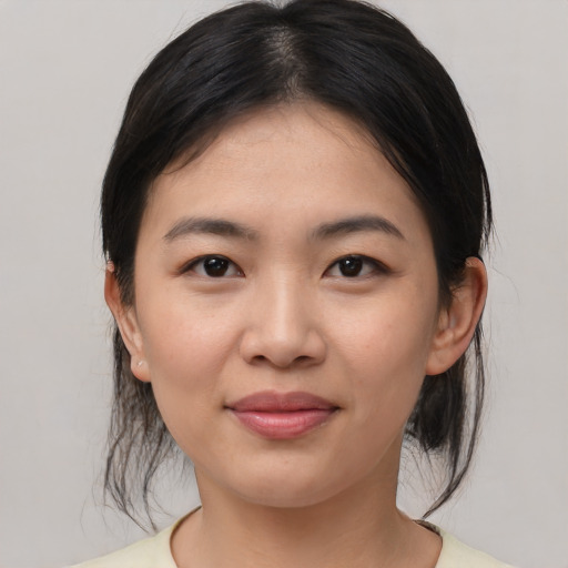 Joyful asian young-adult female with medium  brown hair and brown eyes