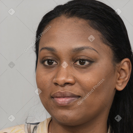 Joyful black young-adult female with long  brown hair and brown eyes