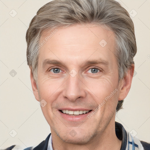 Joyful white adult male with short  brown hair and grey eyes