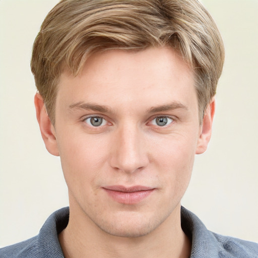 Joyful white young-adult male with short  brown hair and blue eyes