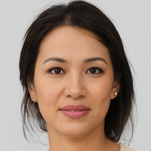 Joyful asian young-adult female with medium  brown hair and brown eyes