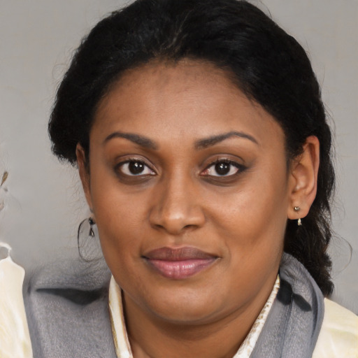 Joyful black young-adult female with medium  brown hair and brown eyes