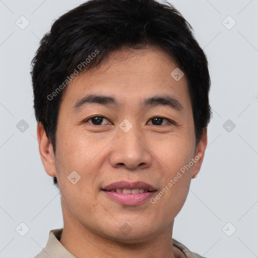 Joyful asian young-adult male with short  brown hair and brown eyes