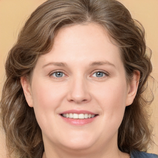 Joyful white young-adult female with medium  brown hair and blue eyes