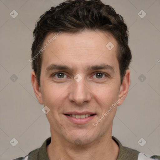 Joyful white adult male with short  brown hair and grey eyes