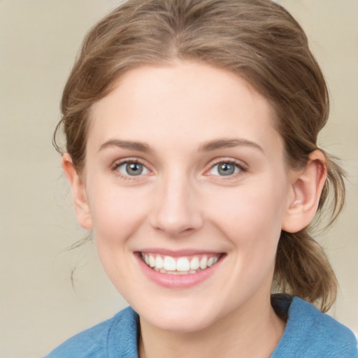 Joyful white young-adult female with medium  brown hair and blue eyes