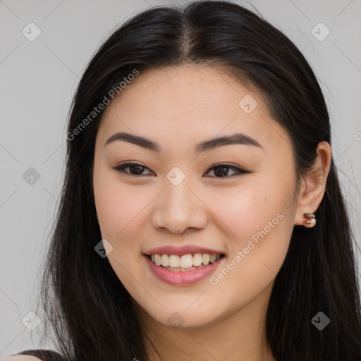 Joyful asian young-adult female with long  brown hair and brown eyes