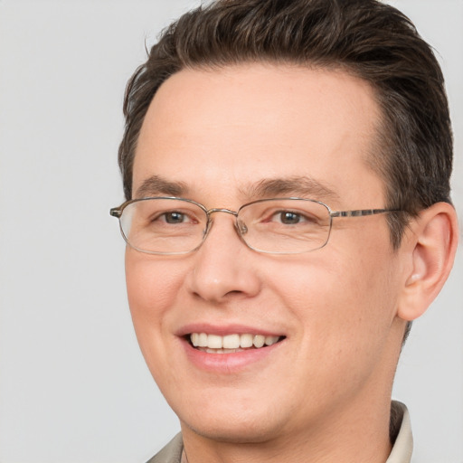 Joyful white adult male with short  brown hair and brown eyes